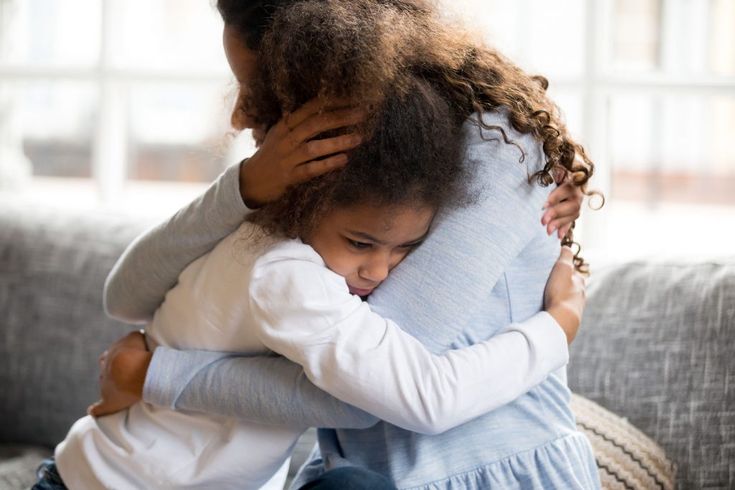 Mãe abraçando criança